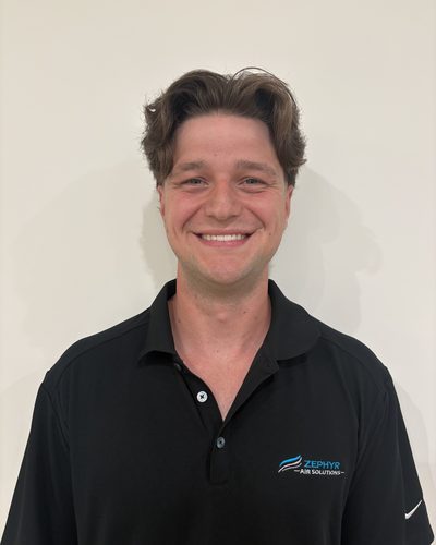 Jacob Middleton, co-founder of Zephyr Air Solutions, smiling in a black Zephyr Air Solutions polo shirt