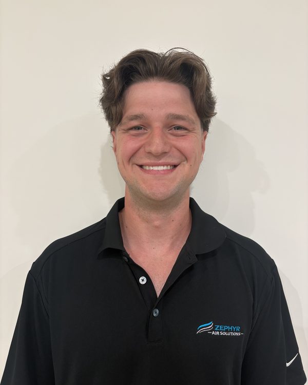 Jacob Middleton, co-founder of Zephyr Air Solutions, smiling in a black Zephyr Air Solutions polo shirt